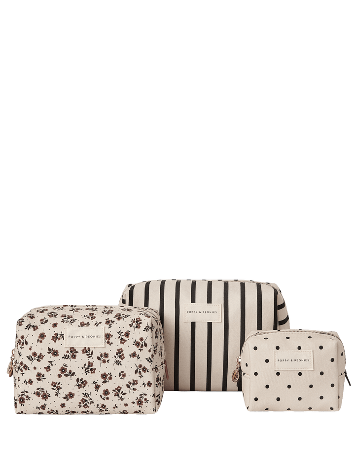 Three cosmetic bags with floral, striped, and polka dot patterns on a white background.