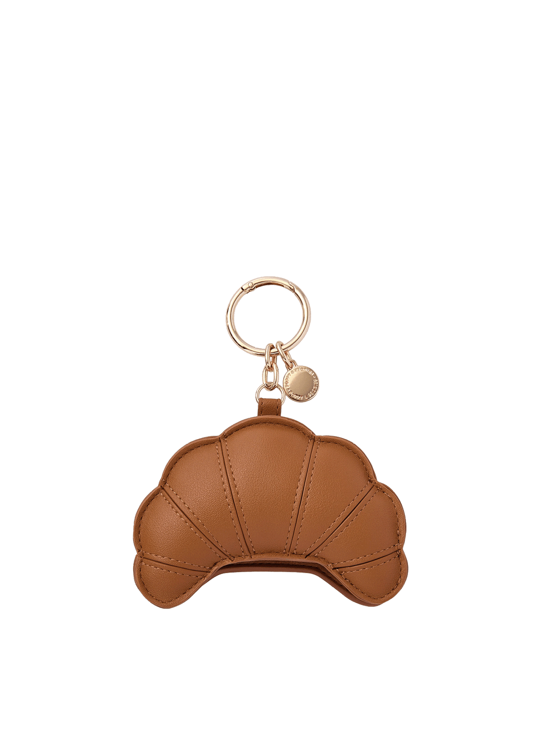 Poppy and Peonies Croissant Bag Charm featuring a croissant-shaped design in warm golden brown with textured material, stitched panel details resembling flaky pastry layers, and gold-tone keyring hardware with a small round branded charm.