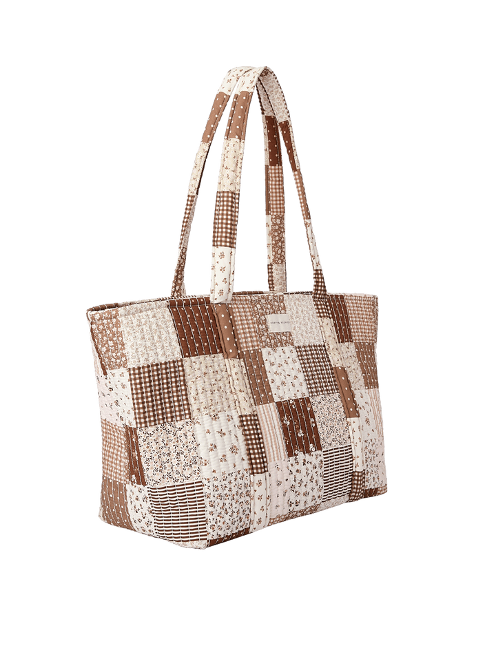 Side profile of the Daydreamer Tote in Brown Patchwork showing structured quilted design
