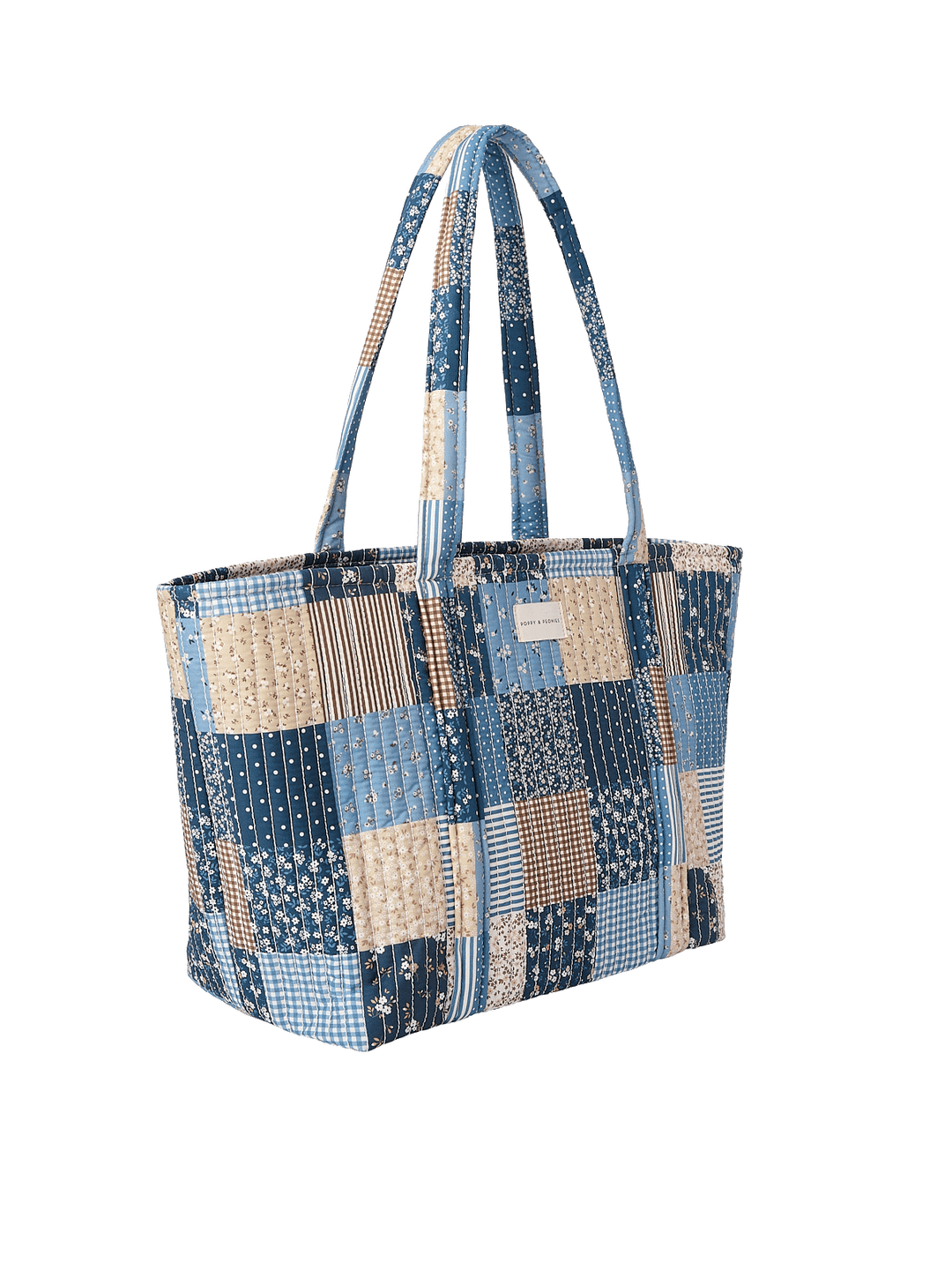 Side profile of the Daydreamer Tote in Navy Patchwork showing structured quilted design