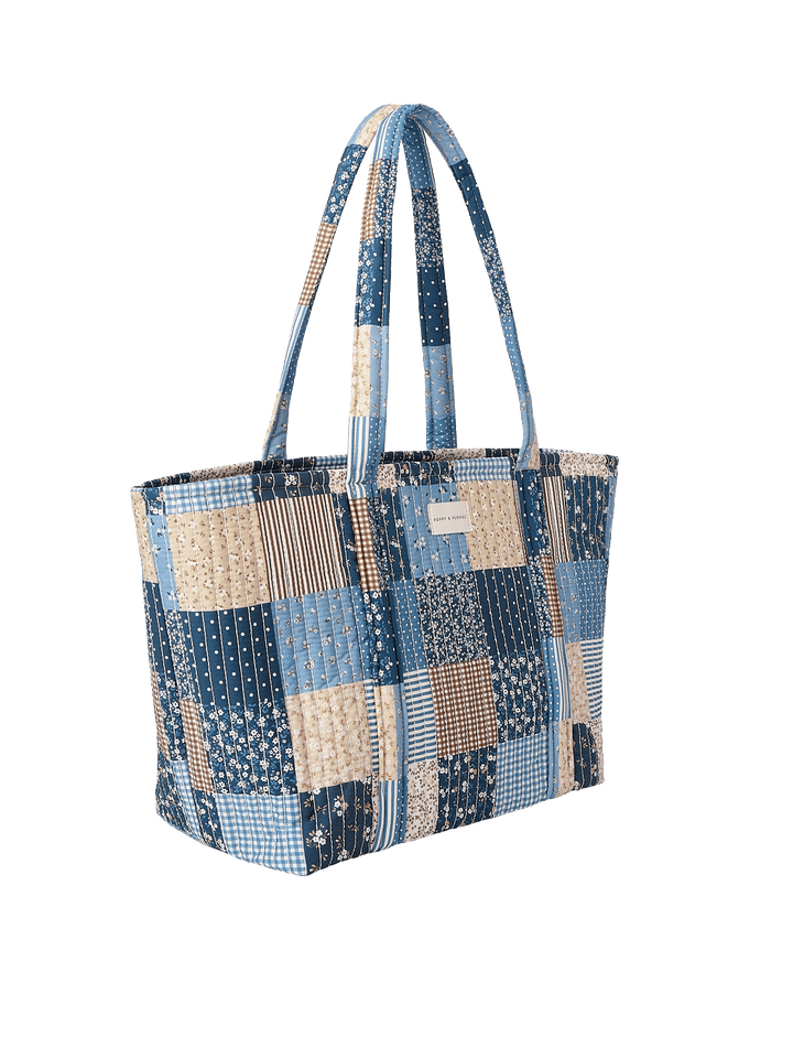 Side profile of the Daydreamer Tote in Navy Patchwork showing structured quilted design