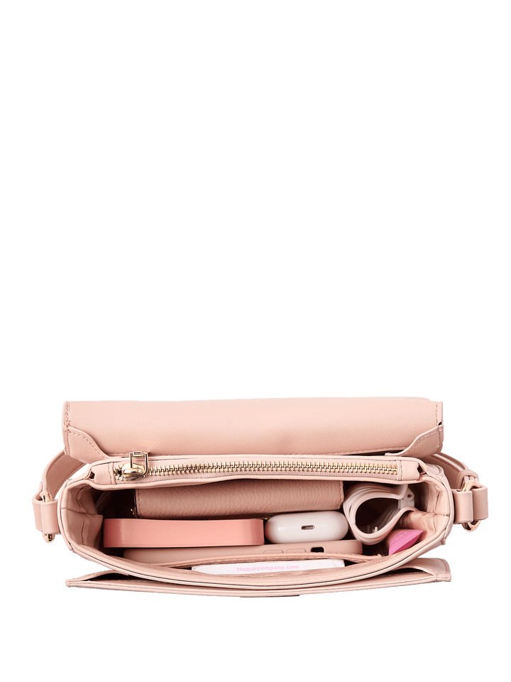 Interior of a pink handbag containing various items