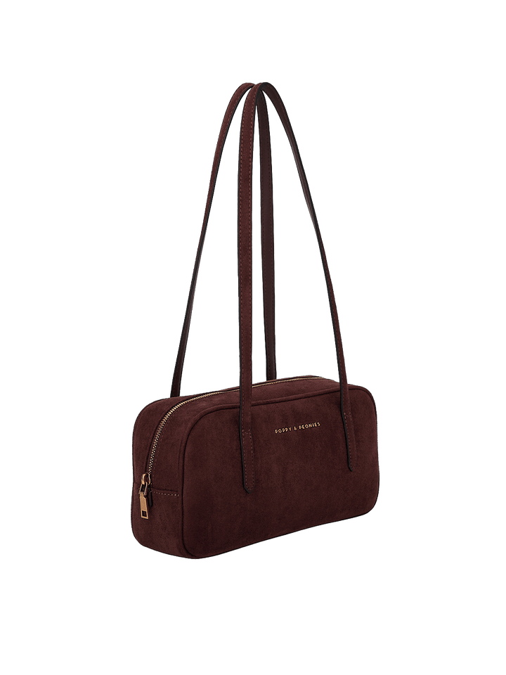 Poppy & Peonies The Friday Satchel in Espresso Suede angled side view, highlighting the slim structured shape, long shoulder straps and gold-tone zipper hardware.