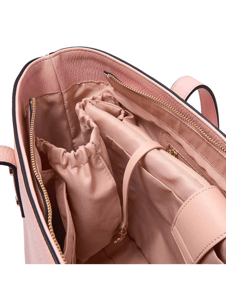 Interior water bottle pocket of a pink vegan leather tote bag 