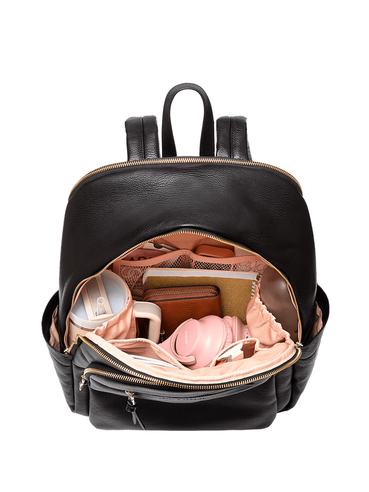 Black backpack with items inside on a transparent background