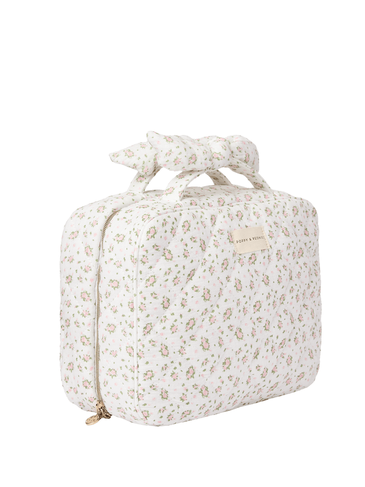Floral-patterned travel toiletry bag with a bow
