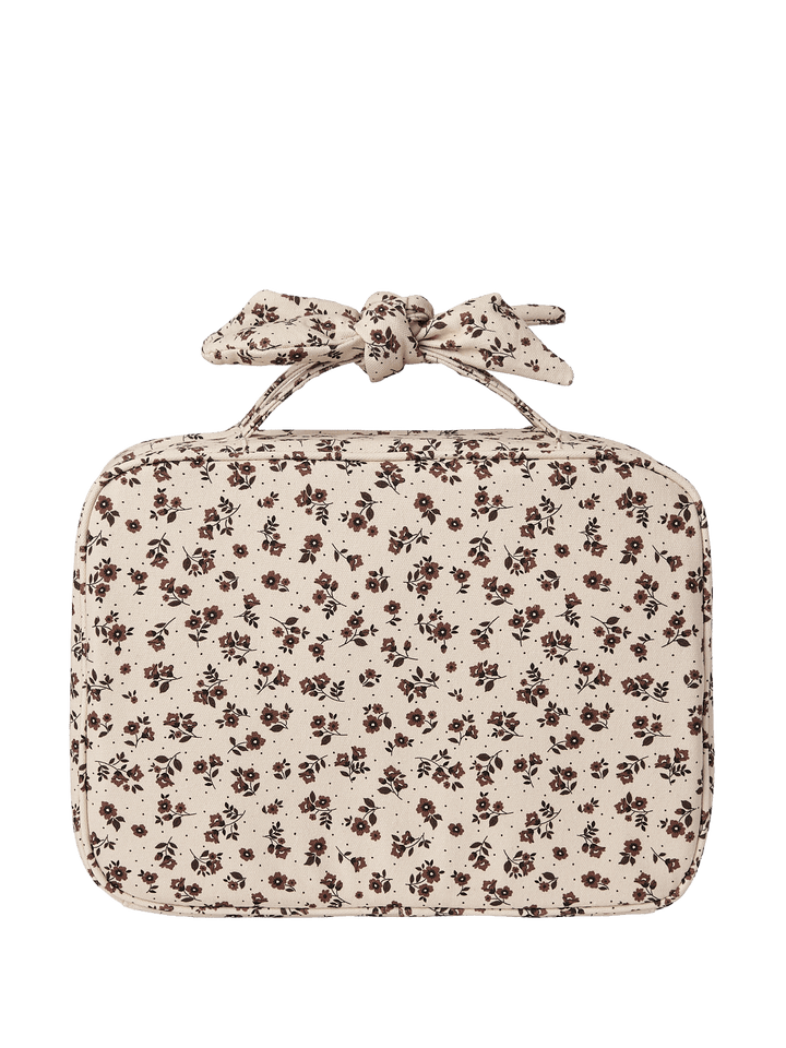 A floral-patterned travel makeup bag with a bow 