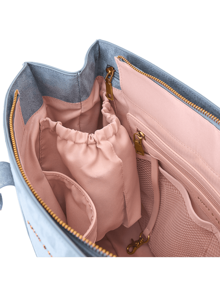 Open tote bag with pink interior and gold zippers