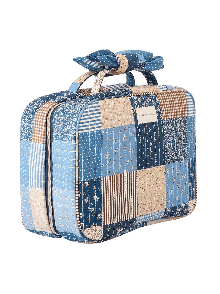 Angled side view of Large Hook Me Up Cosmetic Case in Navy Patchwork