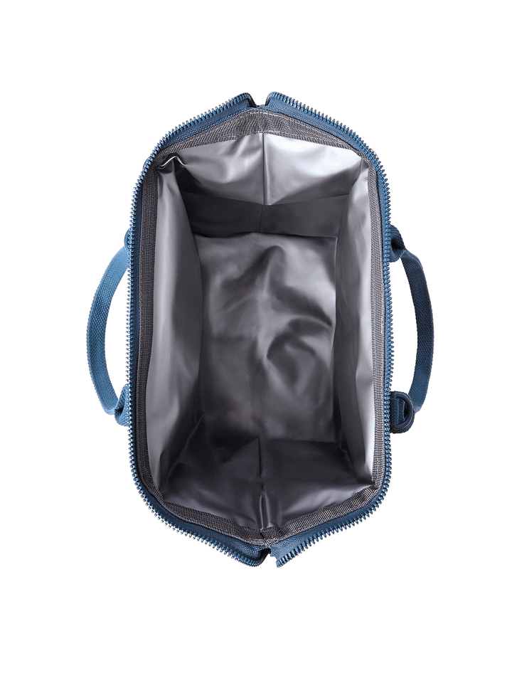Open top view of The Lunch Bag in Navy Patchwork showing insulated leakproof interior