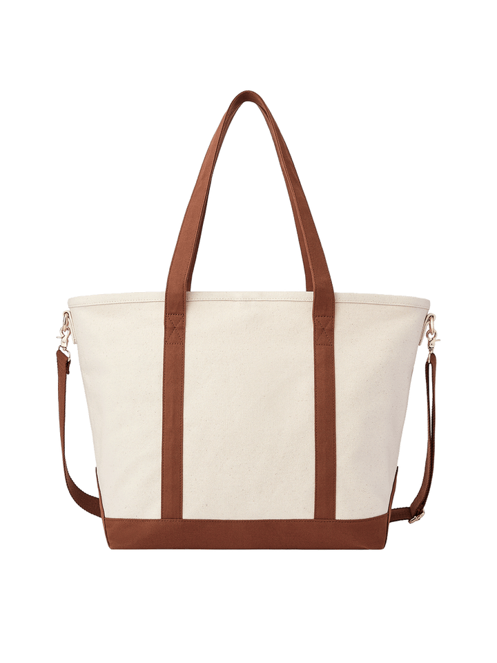 Poppy and Peonies The Signature Tote Chestnut featuring a cream canvas exterior, chestnut brown shoulder straps, matching bottom trim, detachable adjustable crossbody strap, and gold-tone hardware