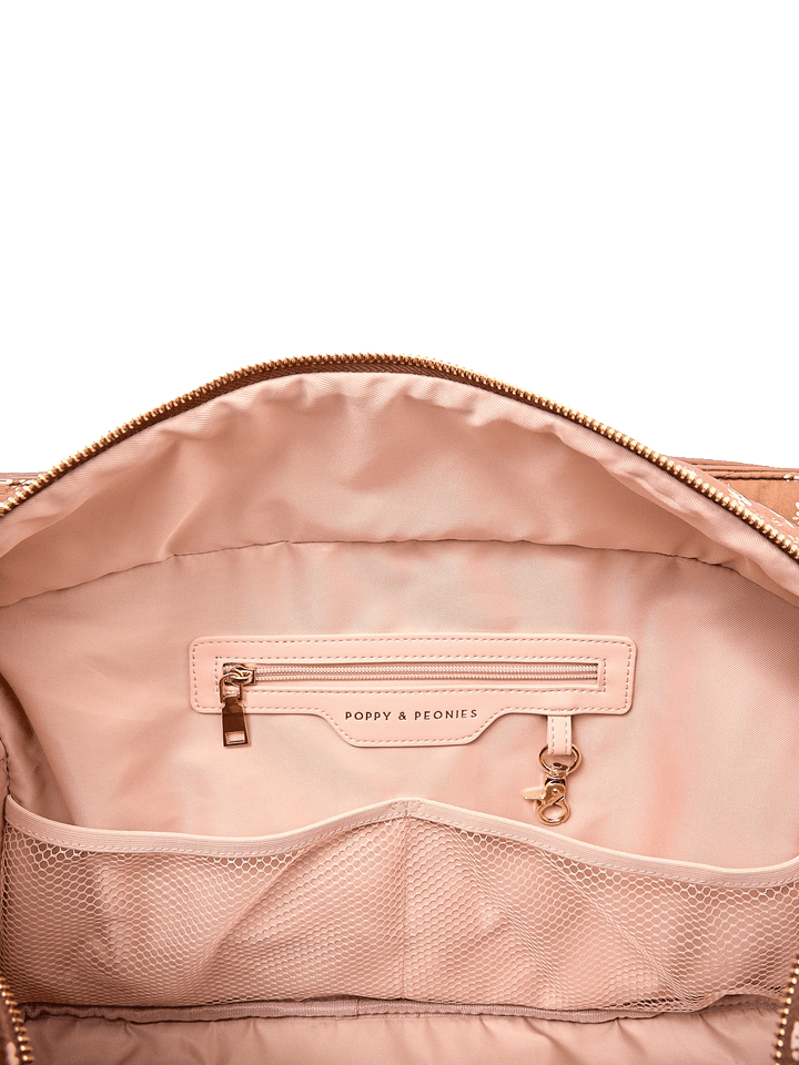 Interior zip pocket and mesh organizer pockets inside Mini Voyager tote in Brown Floral