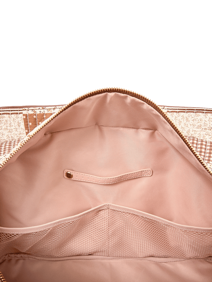 Interior slide pocket and jewelry tab inside Mini Voyager tote in Brown Patchwork