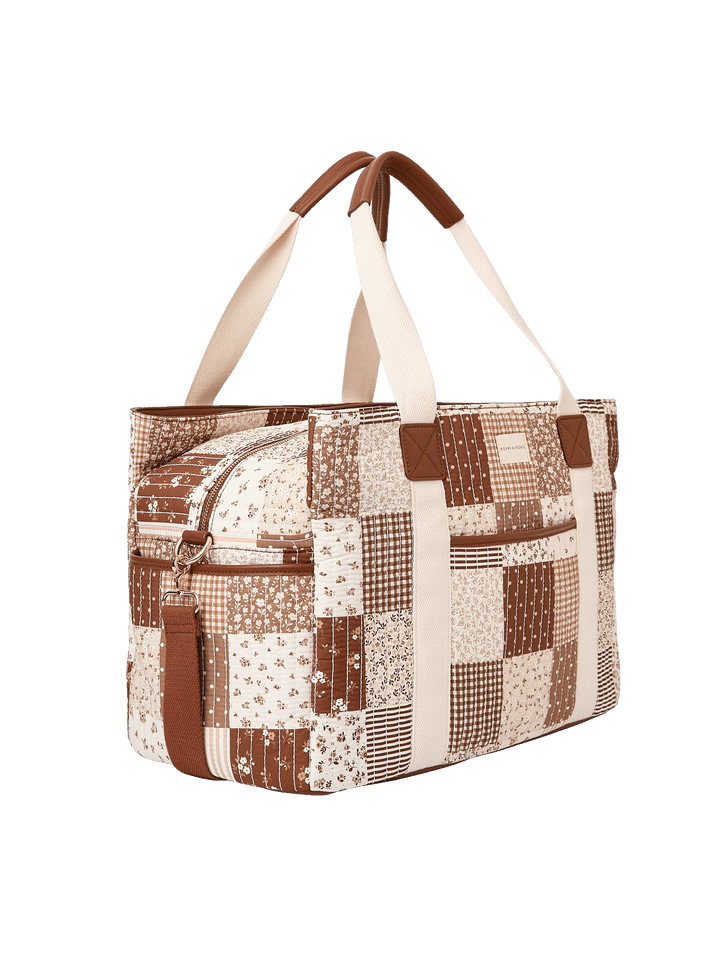 Angled side view of Mini Voyager tote in Brown Patchwork