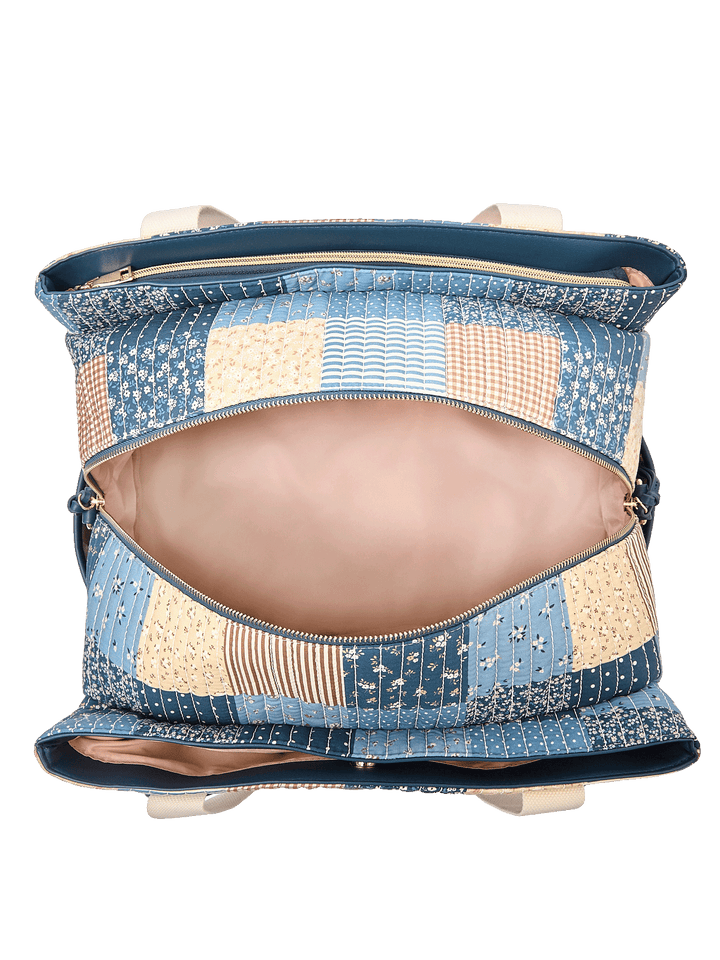 Interior of Mini Voyager tote in Navy Patchwork showing triple-opening compartments and organizer pockets