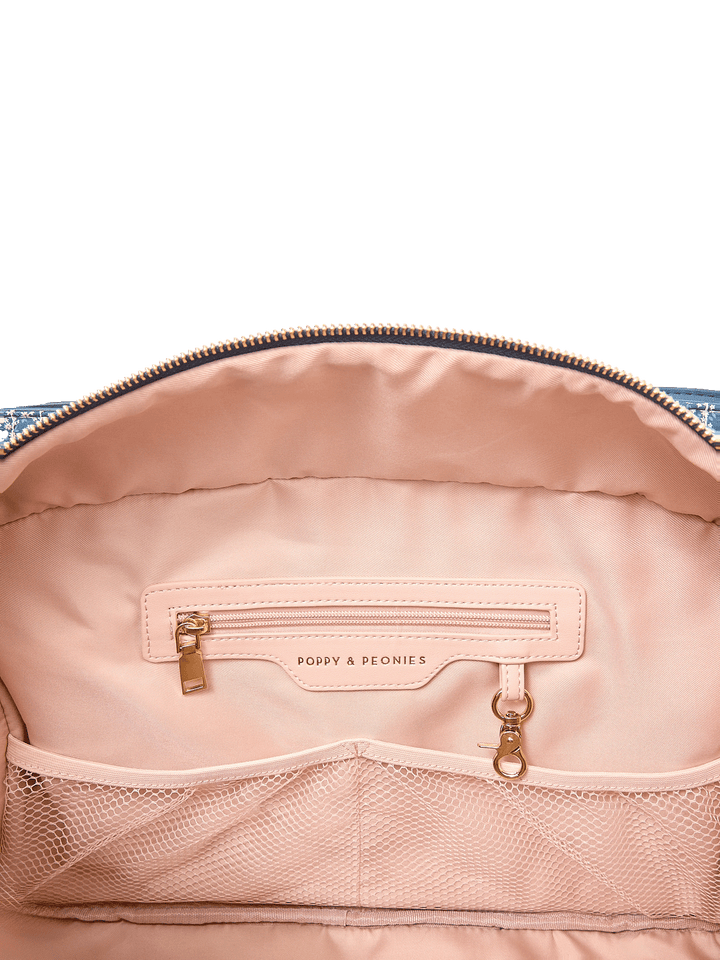 Interior zip pocket and mesh organizer pockets inside Mini Voyager tote in Navy Patchwork