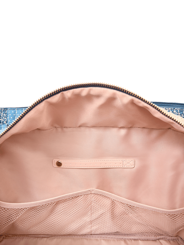 Interior slide pocket and jewelry tab inside Mini Voyager tote in Navy Patchwork
