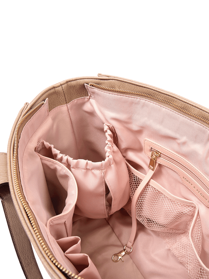 Close-up of Multitasker tote in Taupe interior with mesh pockets, key leash, and water bottle holders