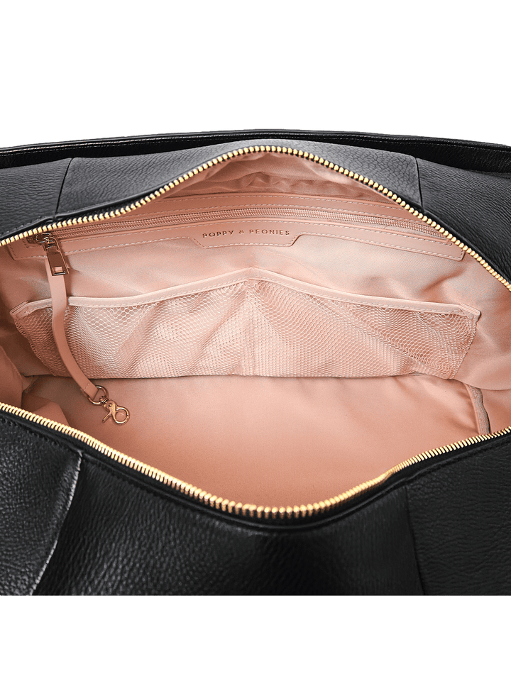 Close up of pockets and a key leash in a duffle bag