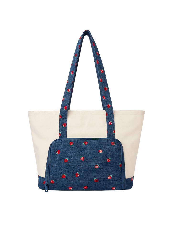 Poppy & Peonies Analog Tote in Strawberry Denim back view, featuring a navy strawberry-print exterior pocket, long shoulder straps and cream canvas exterior.
