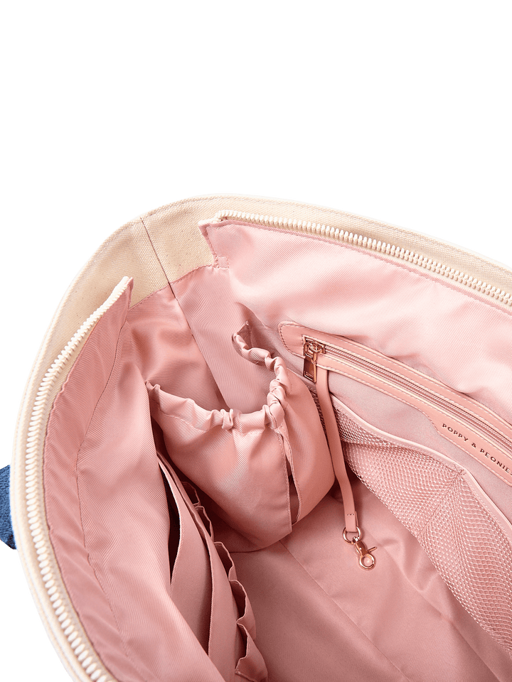 Poppy & Peonies Analog Tote in Strawberry Denim interior close-up, featuring blush-pink lining, elastic holders, mesh pocket, zippered pocket and key leash.