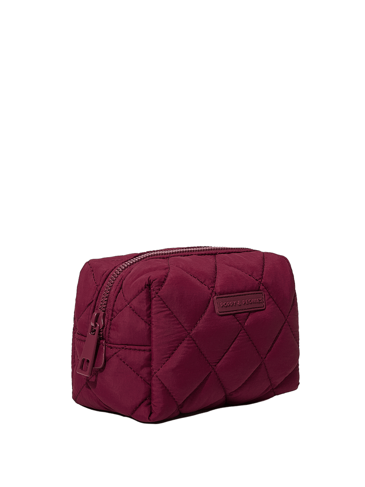 Quilted berry coloured cosmetic bag on a transparent background