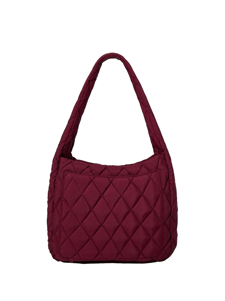Back of a berry coloured quilted handbag on a transparent background