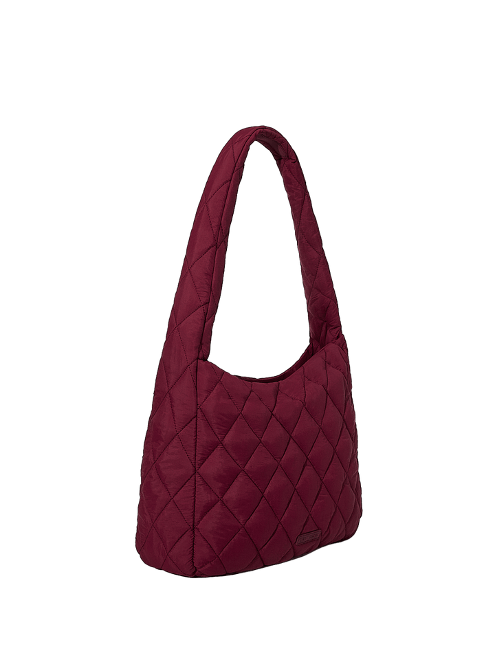 Quilted handbag with a diamond pattern on a transparent background