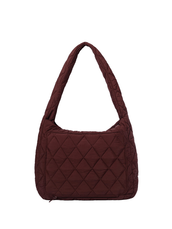 Quilted brown handbag on a transparent background