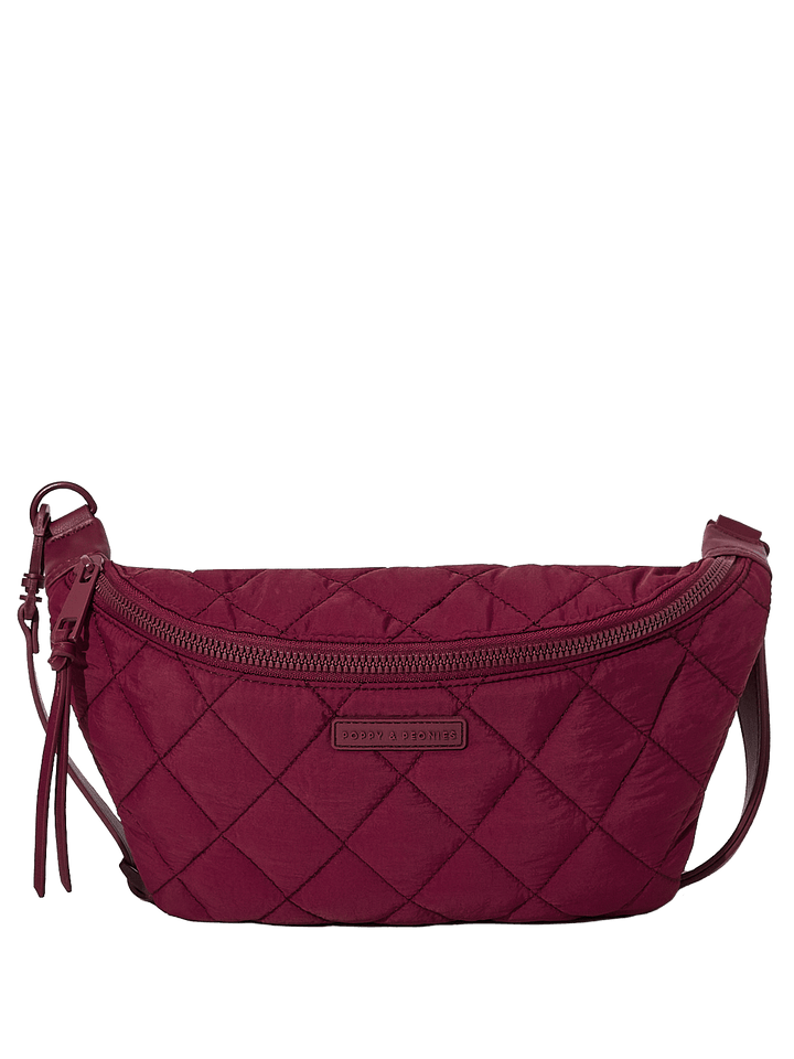 Quilted berry coloured handbag with a visible brand label on a transparent background