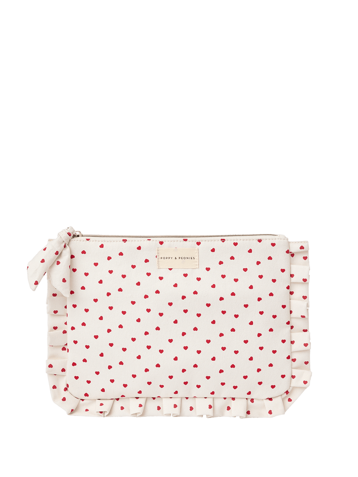 White clutch with red heart pattern