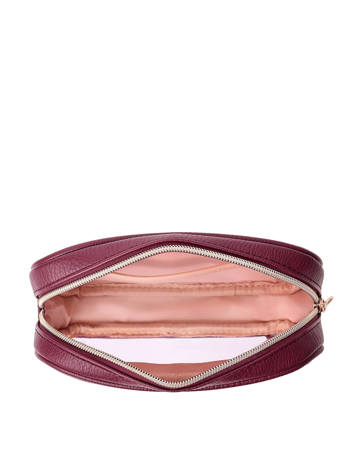 Open view of The Split Organizer in Berry showing wipeable interior and jewelry tab