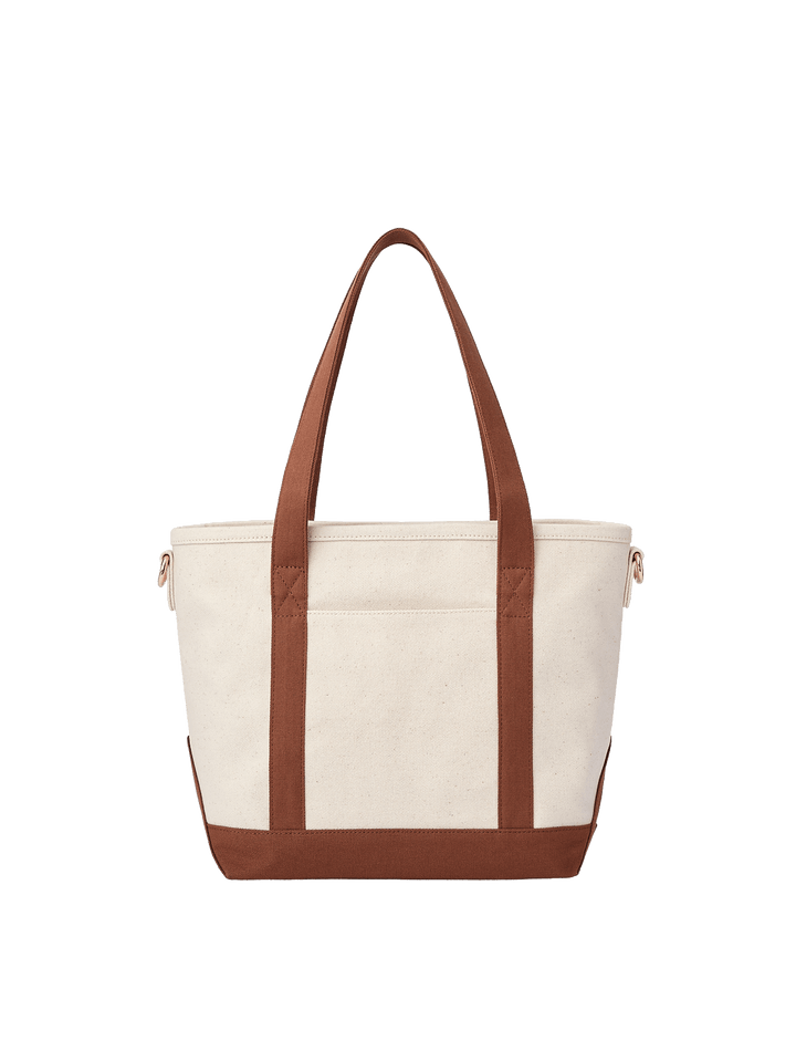 Back view of Poppy & Peonies The Small Signature Tote in Chestnut, highlighting the cream canvas exterior, chestnut brown handles and reinforced base.