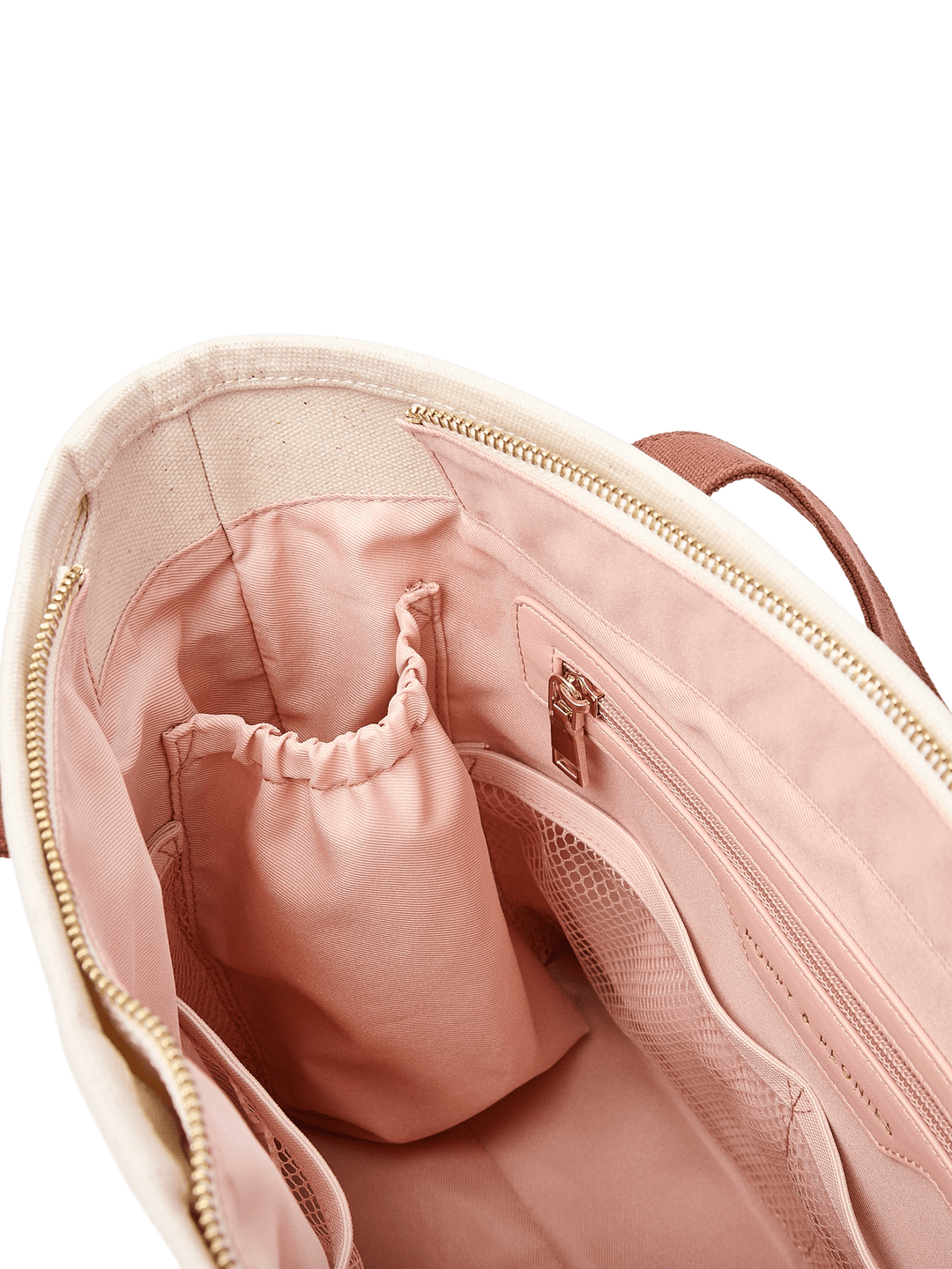 Close-up of the blush pink interior of Poppy & Peonies The Small Signature Tote in Chestnut, featuring elasticated organizer pockets and a zippered compartment.