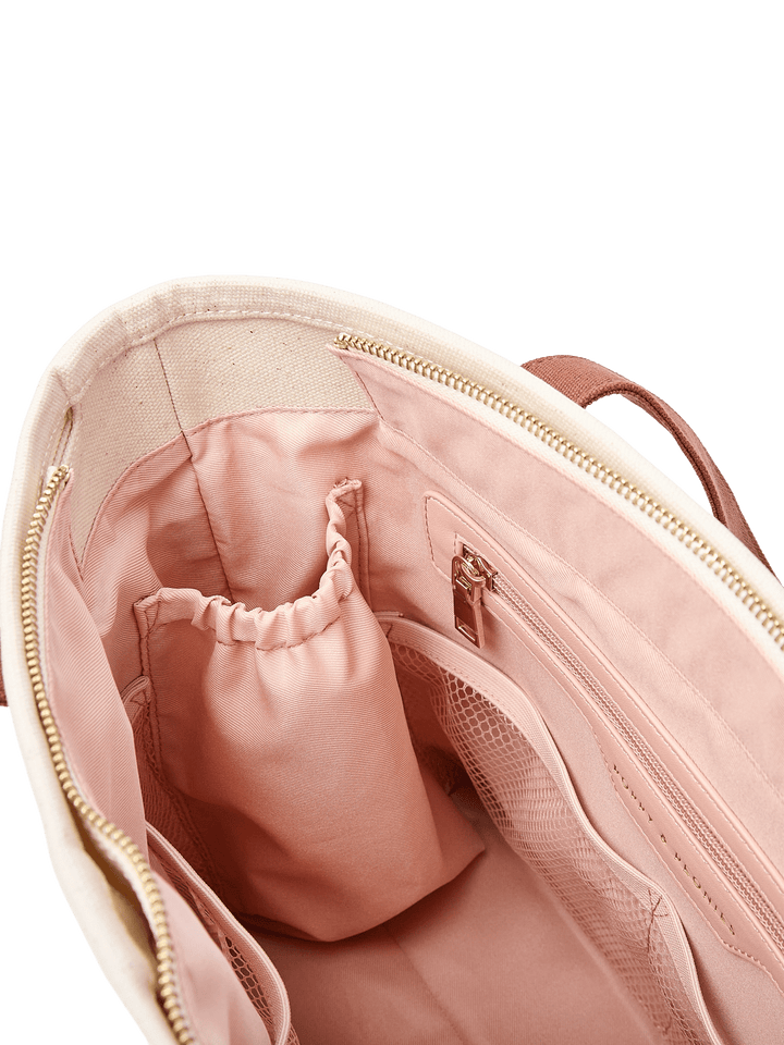 Close-up of the blush pink interior of Poppy & Peonies The Small Signature Tote in Chestnut, featuring elasticated organizer pockets and a zippered compartment.