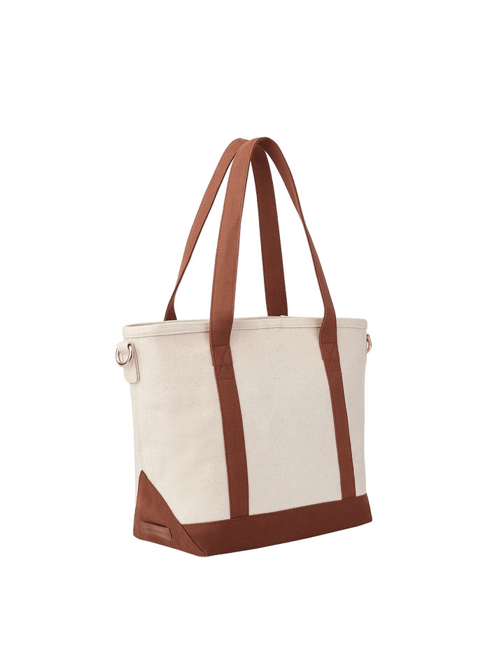 Angled product view of Poppy & Peonies The Small Signature Tote in Chestnut, featuring long brown handles, cream canvas panels and a structured matching base.