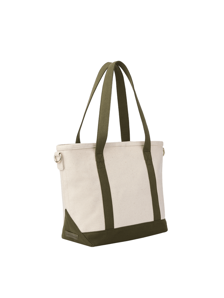 Poppy & Peonies The Small Signature Tote in Olive, angled back view featuring a cream canvas exterior, long olive green handles, matching reinforced base and corner details, and gold-tone hardware for an optional shoulder strap.