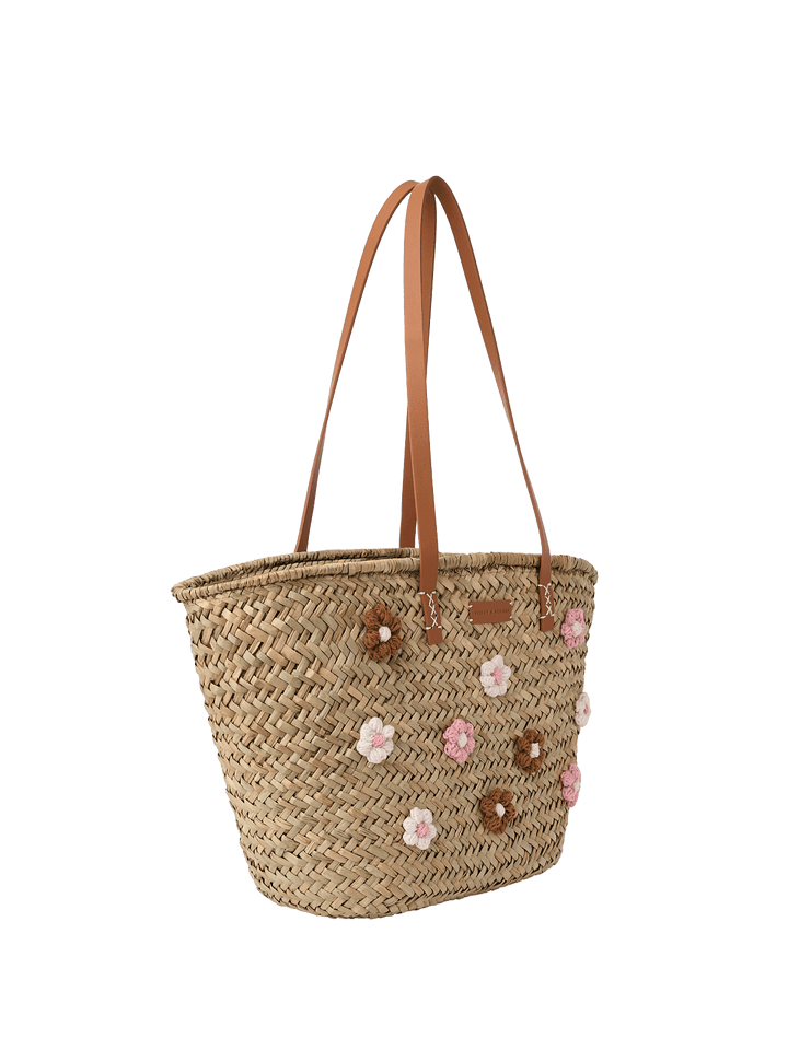 Woven straw tote with floral embellishments and brown vegan leather straps