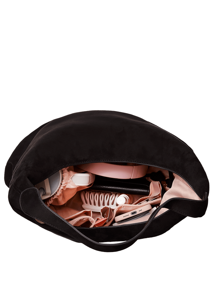 Interior of a black vegan suede hobo style shoulder bag on a transparent background