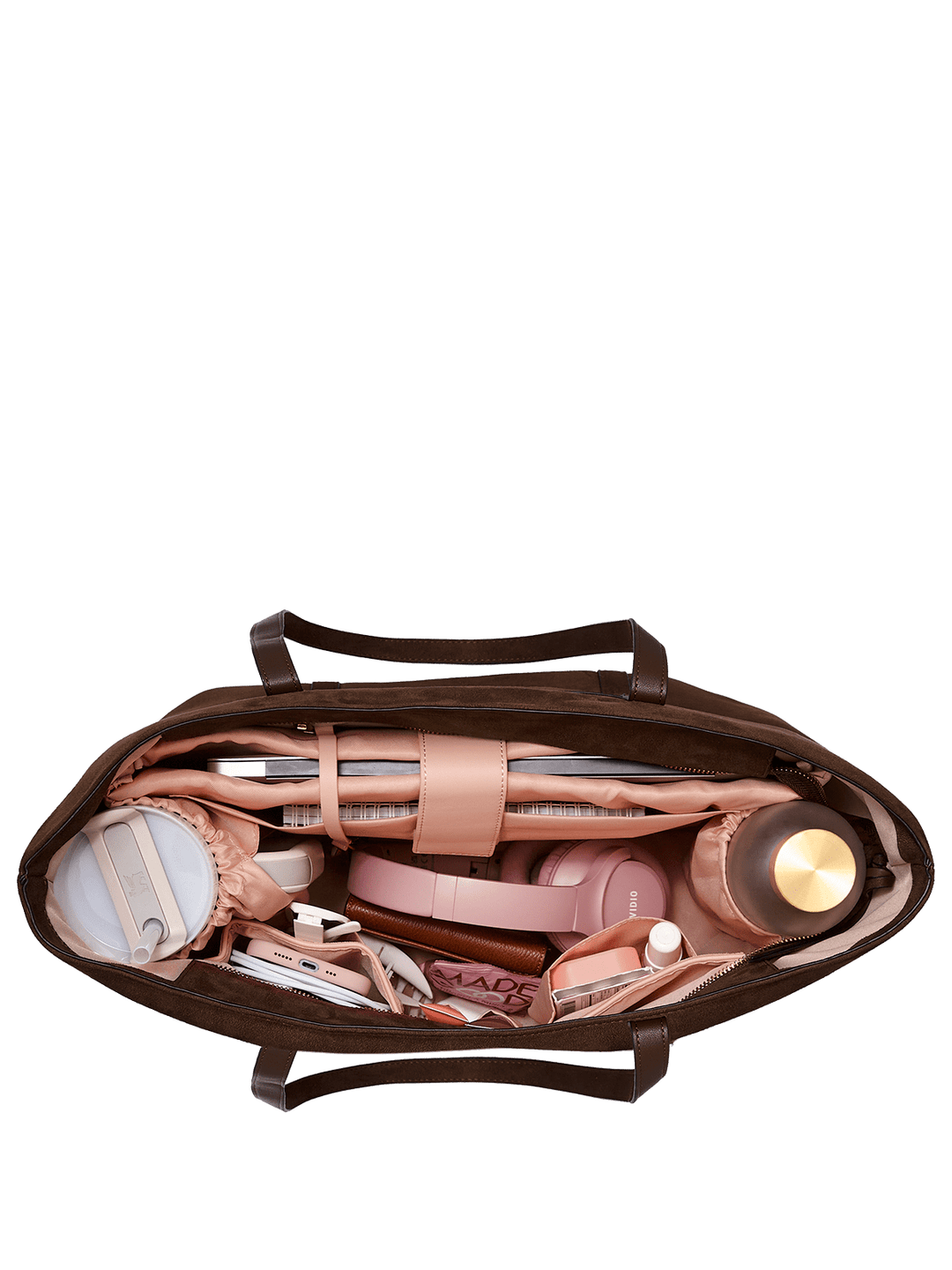 Open brown leather bag with various items on a transparent background