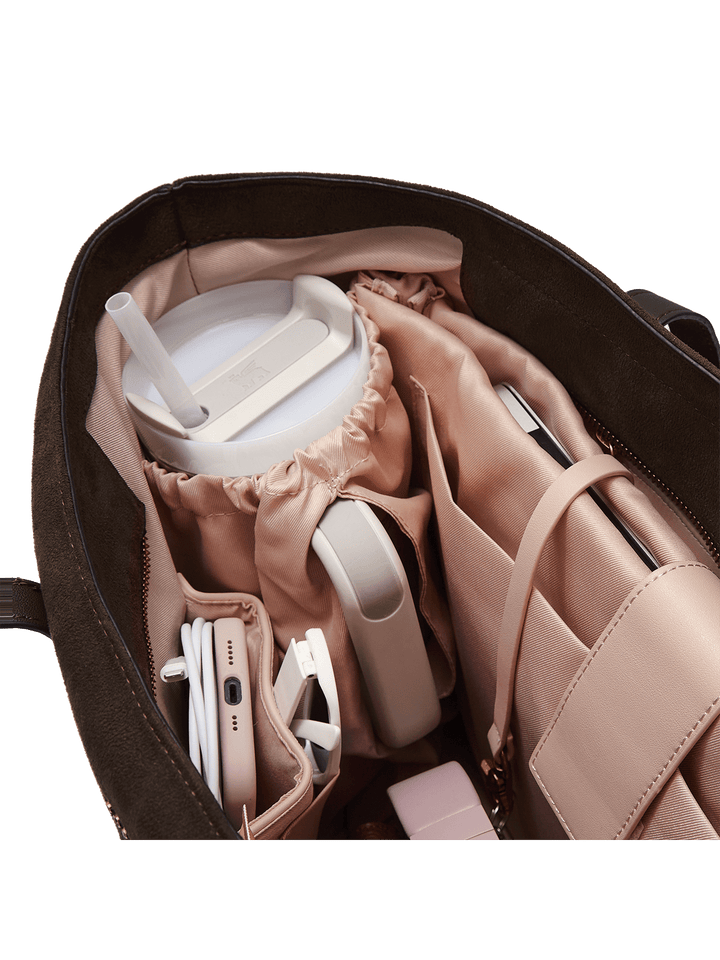 Tote bag with compartments containing electronic devices on a transparent background