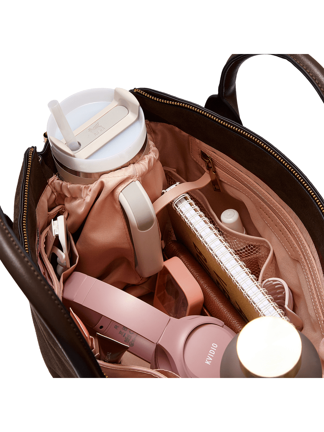 Open bag with pink headphones, water bottle, and other items on a transparent background