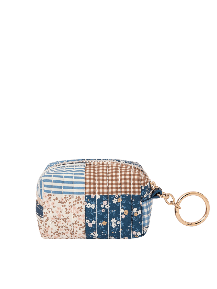 Side view of the Tag Along Charm in Navy Patchwork with gold-tone O-clasp
