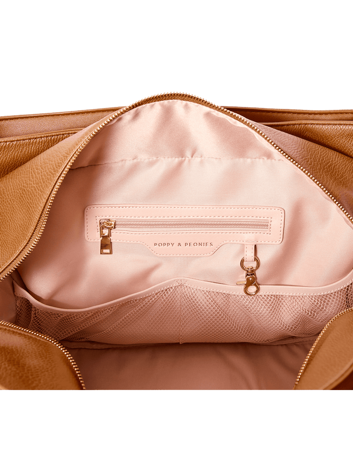 Brown vegan leather handbag with pink interior lining
