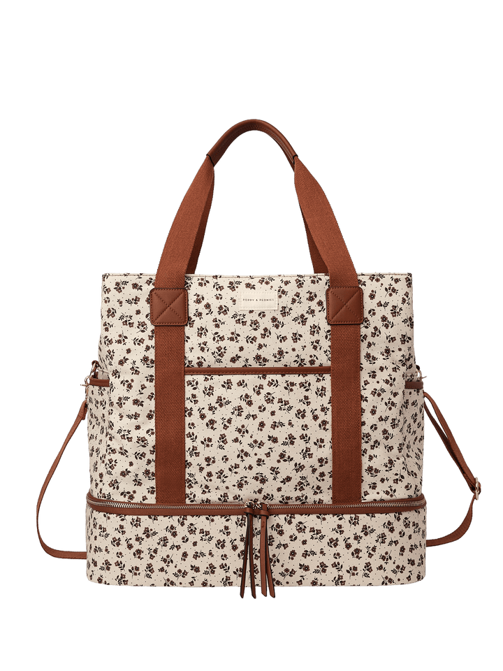 Floral-patterned travel bag with brown straps