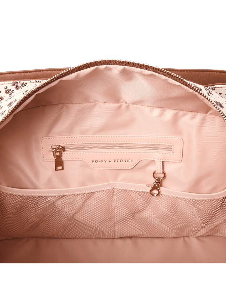 Close-up of the interior of a travel bag showcasing the pockets and key leash