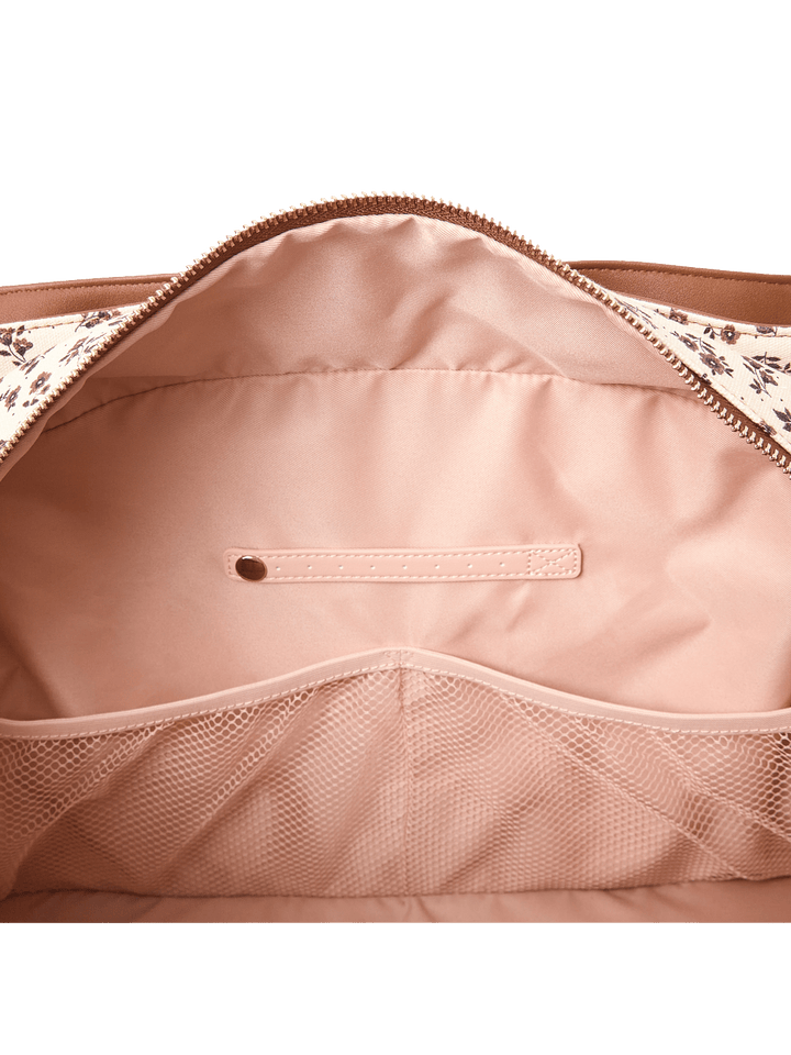 Close-up of the interior of a travel bag showcasing the pockets and a jewelry tab