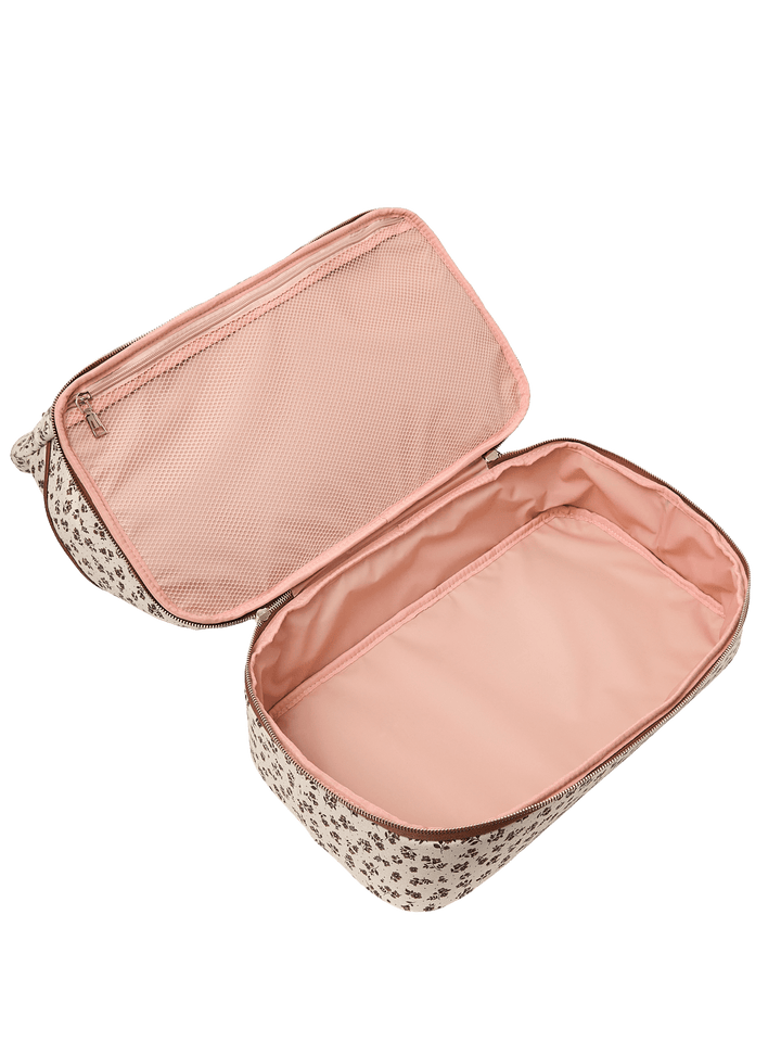 Open pink travel bag with floral pattern.