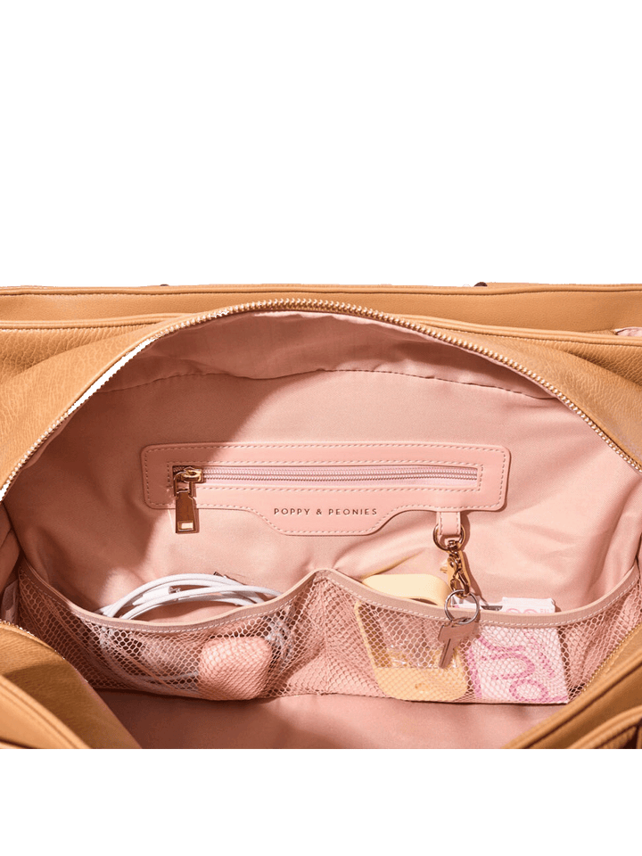 Open vegan leather travel bag with pink interior