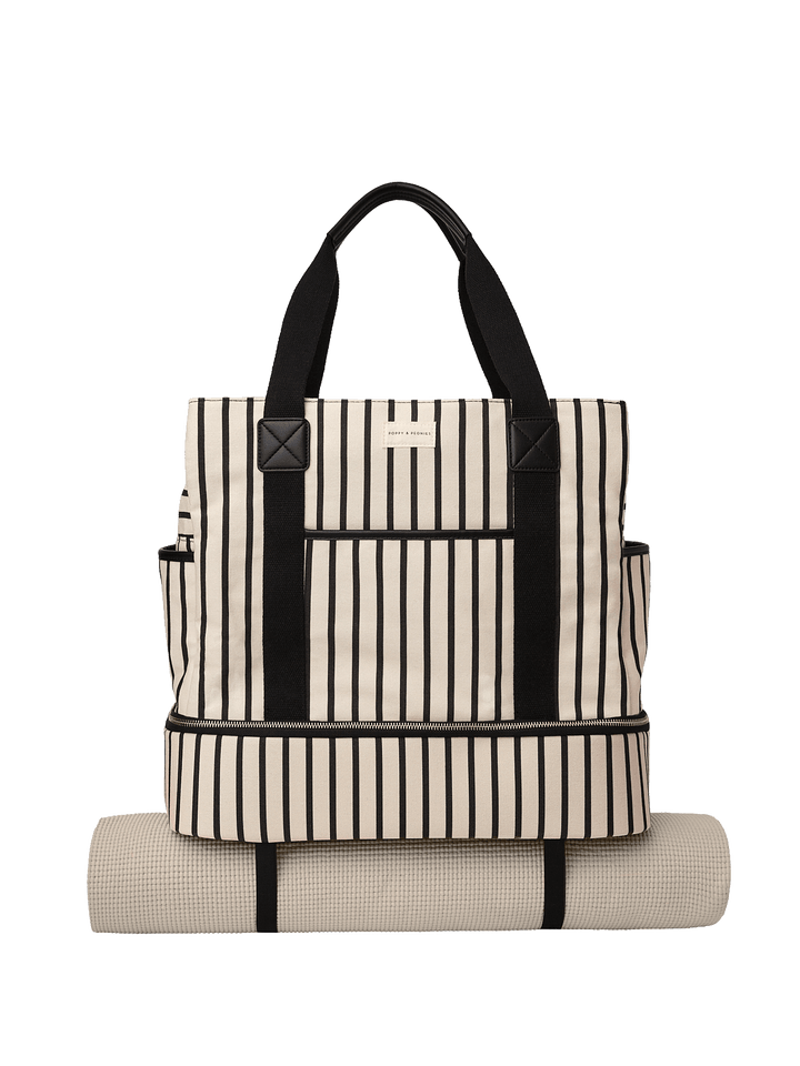 Striped tote bag with black straps and a matching yoga mat attached